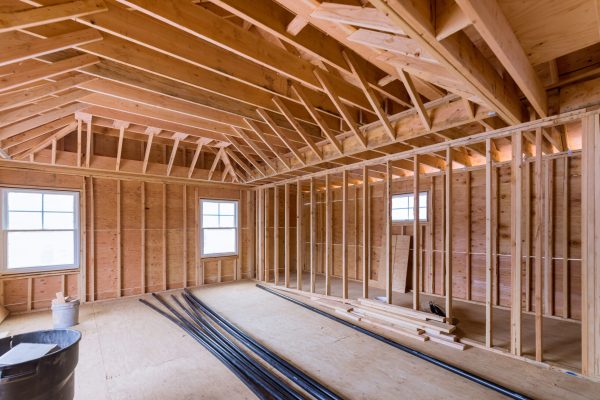 Fragment view beams stick built of new home under construction wood framing beam framework